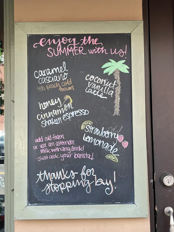Tall summer café menu board with colorful hand lettering and illustrated drinks