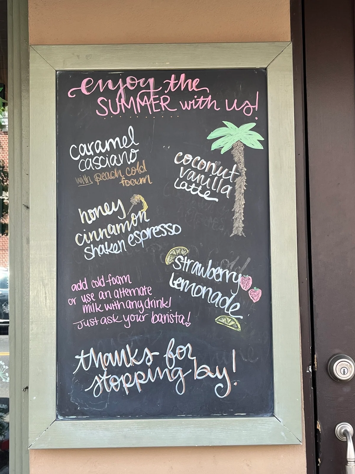 Tall summer café menu board with colorful hand lettering and illustrated drinks