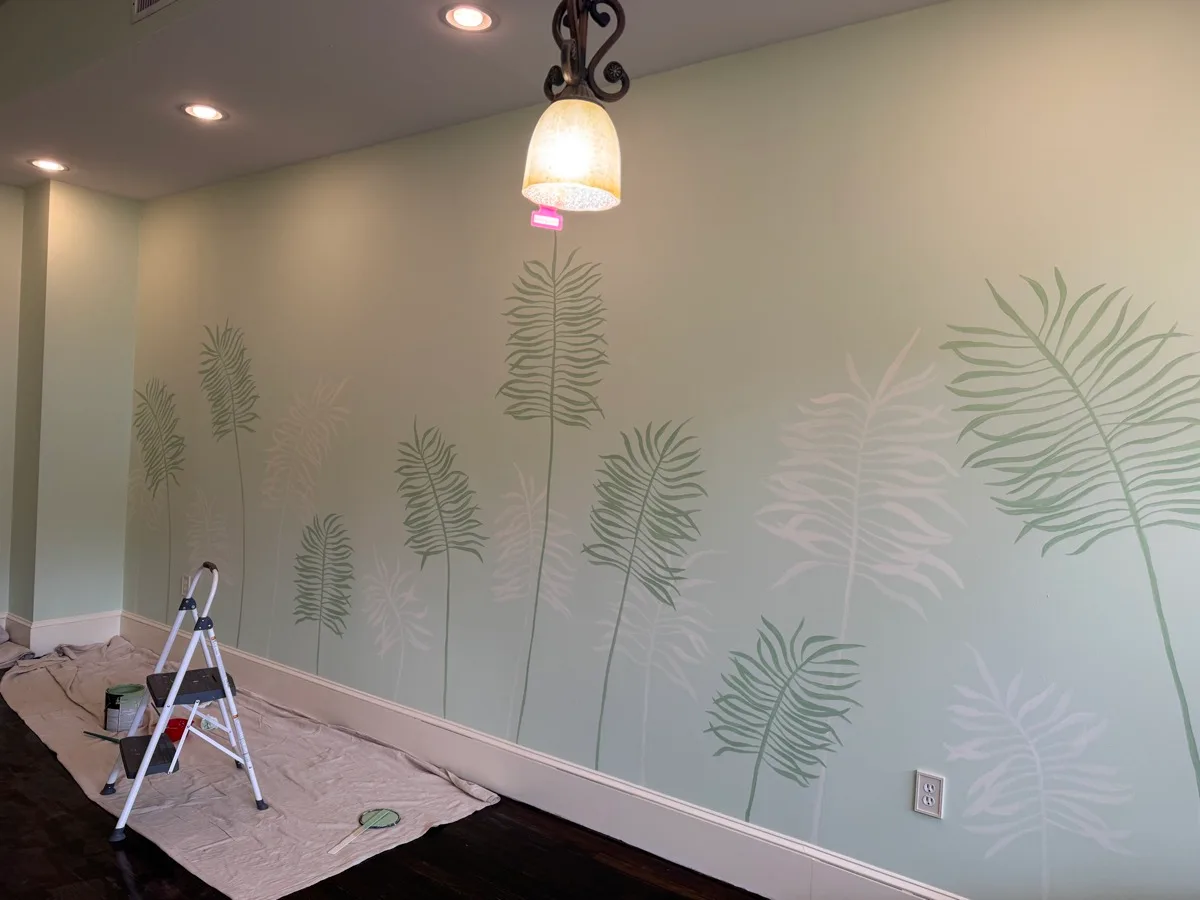 Wide view of a botanical interior wall mural filled with tall layered ferns
