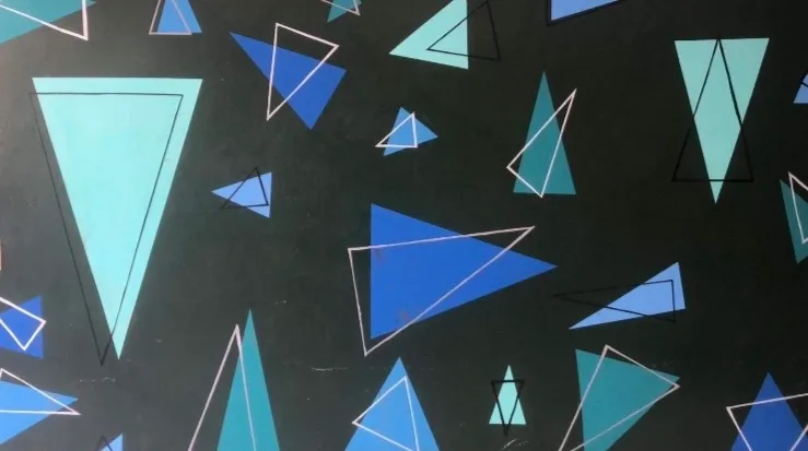 Black mural wall covered with layered blue and teal geometric shapes