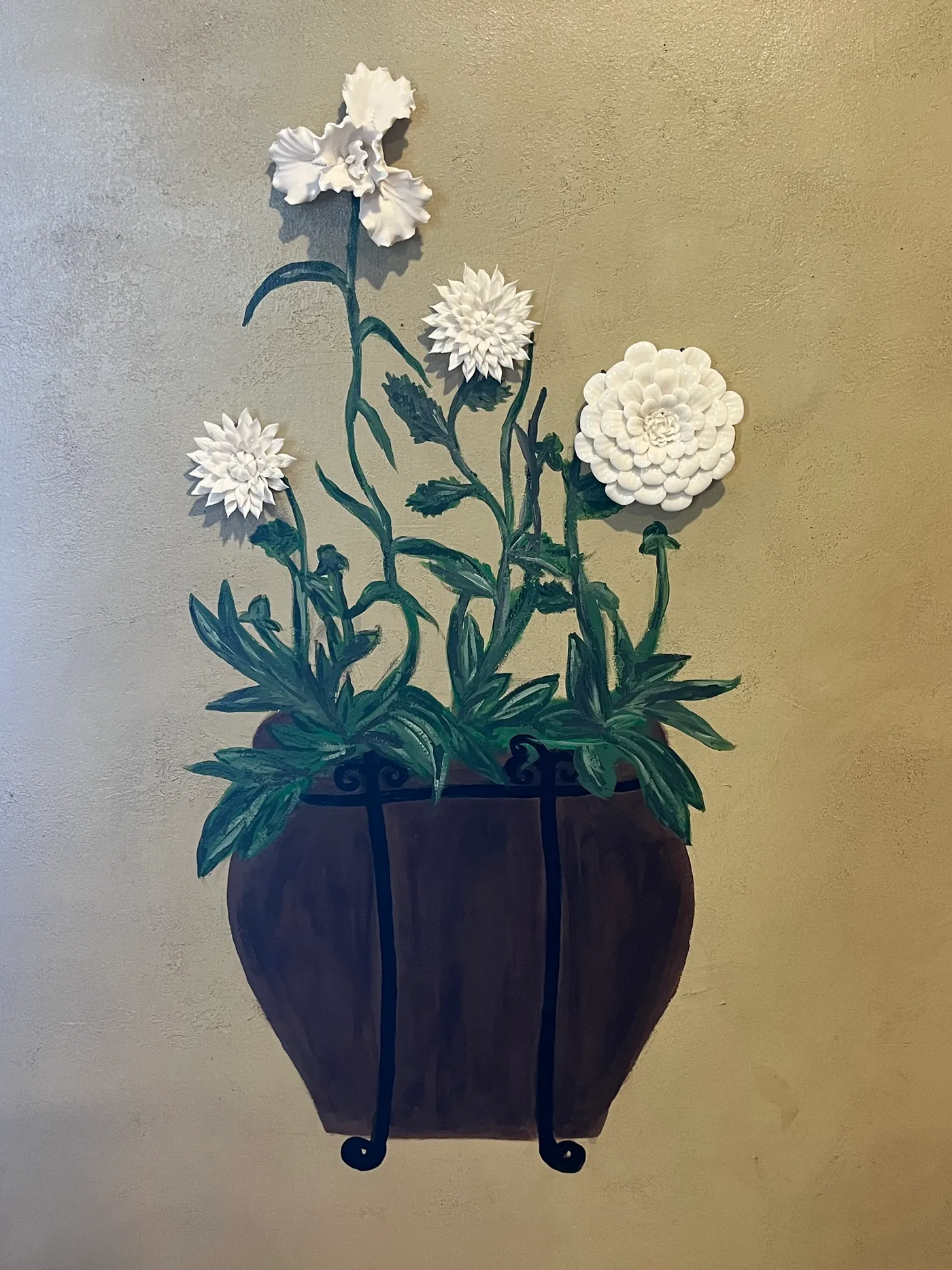 Indoor wall mural of a painted flower box with dimensional white blooms