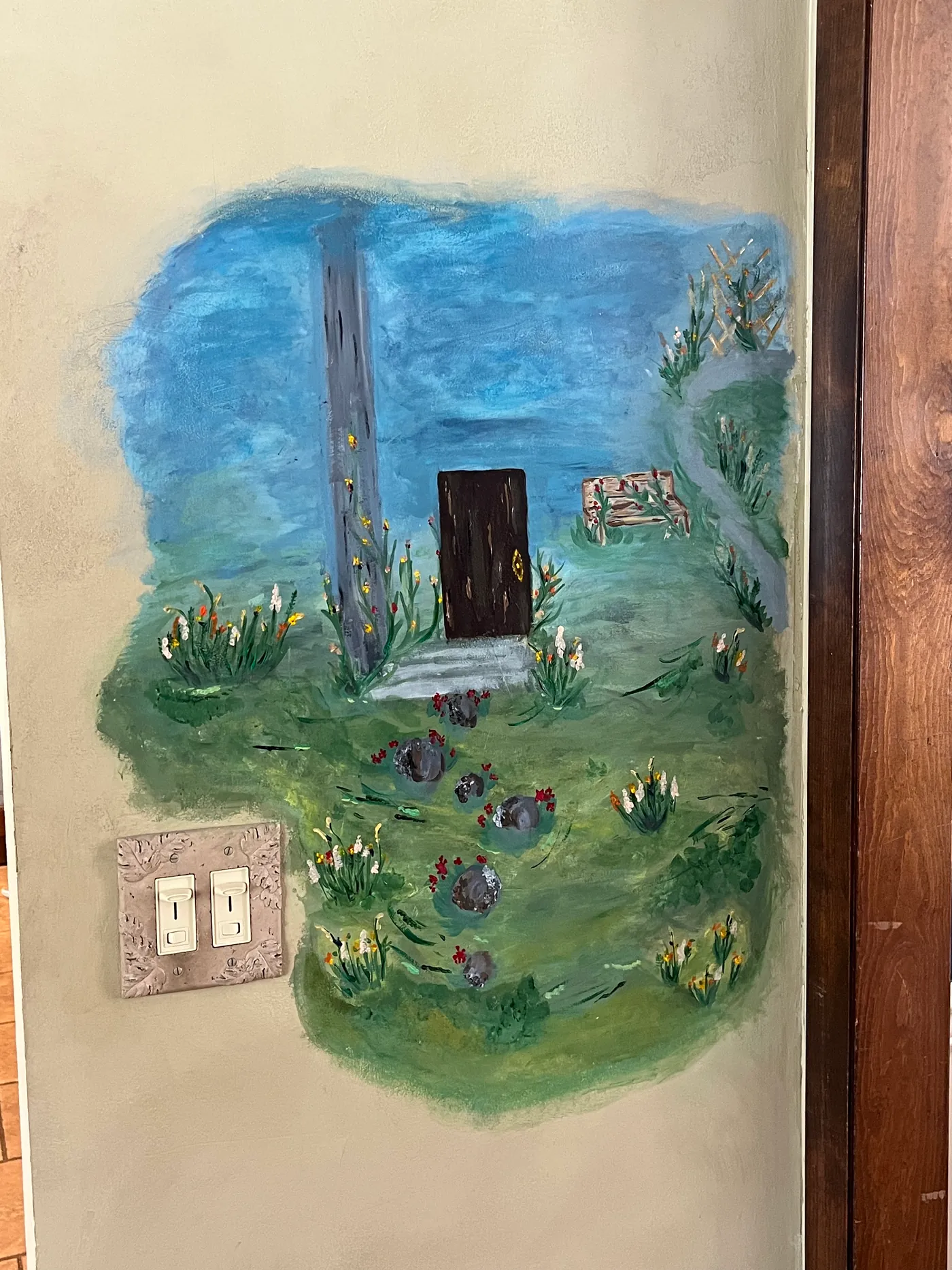 Small storybook garden mural painted beside an interior doorway